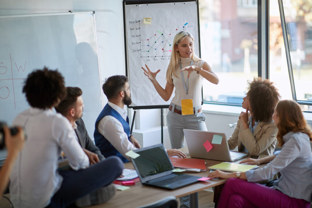 Business woman present her idea to working team.Business colleagues talking about plan or new project.